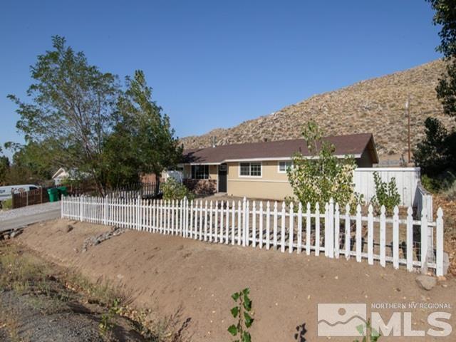 a front view of a house with a fence