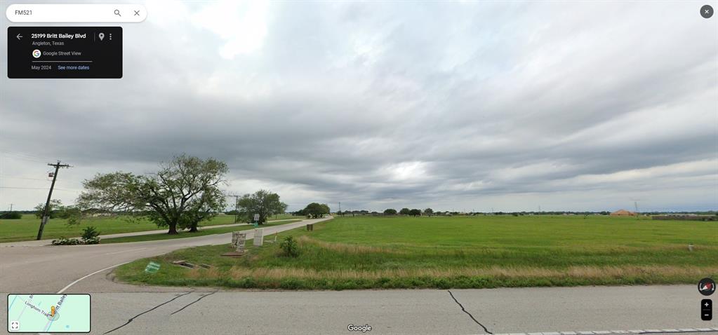 a view of a pathway both side of grassy field with shrub