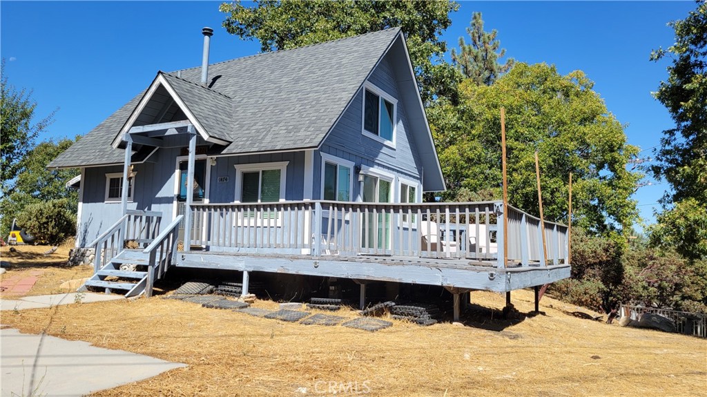 a view of a house with wooden deck