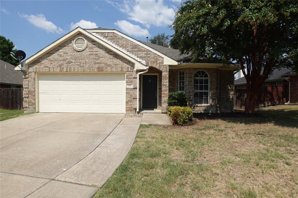 Ranch-style home with a garage and a front yard