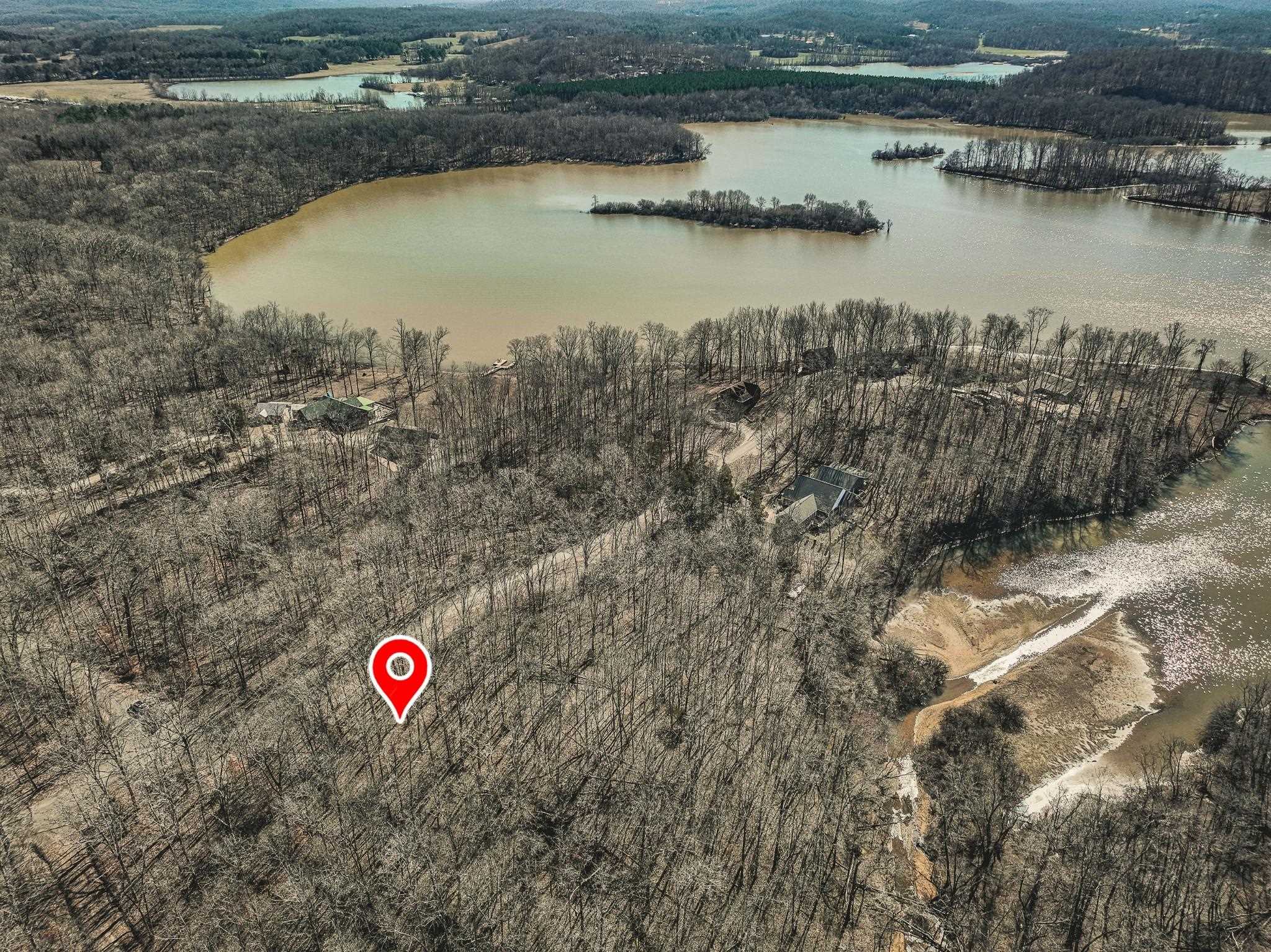 Birds eye view of property with a water view