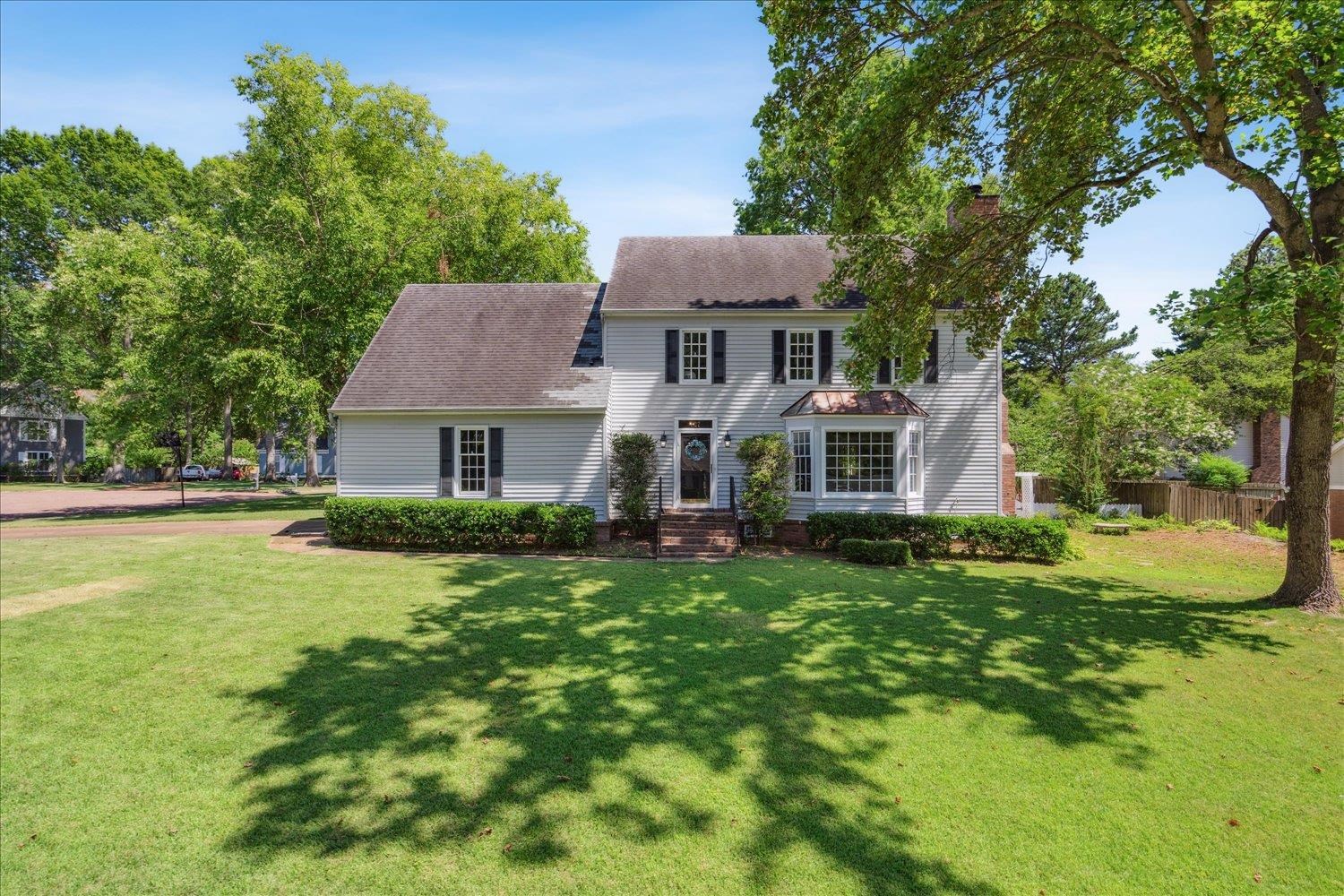 Colonial home featuring a front yard