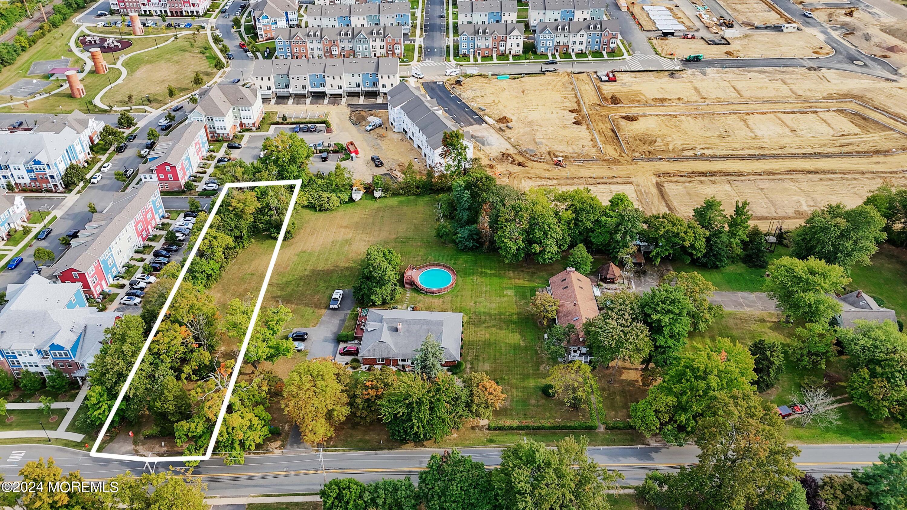 an aerial view of a house with a yard and lake view