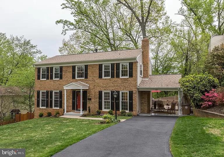 front view of a brick house with a yard