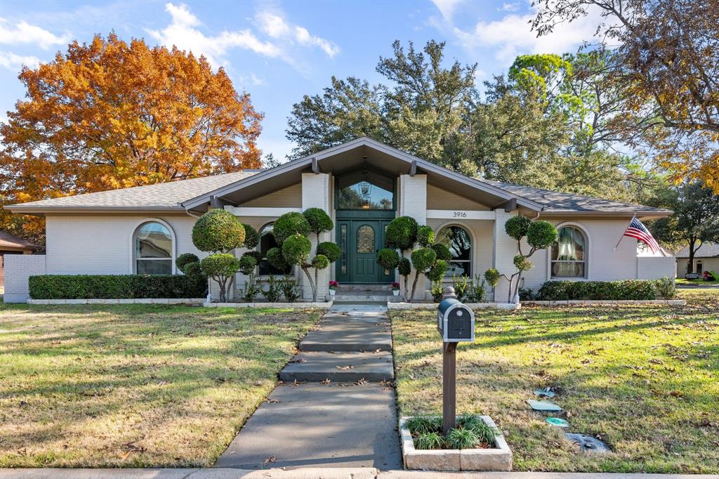 a front view of house with yard and green space