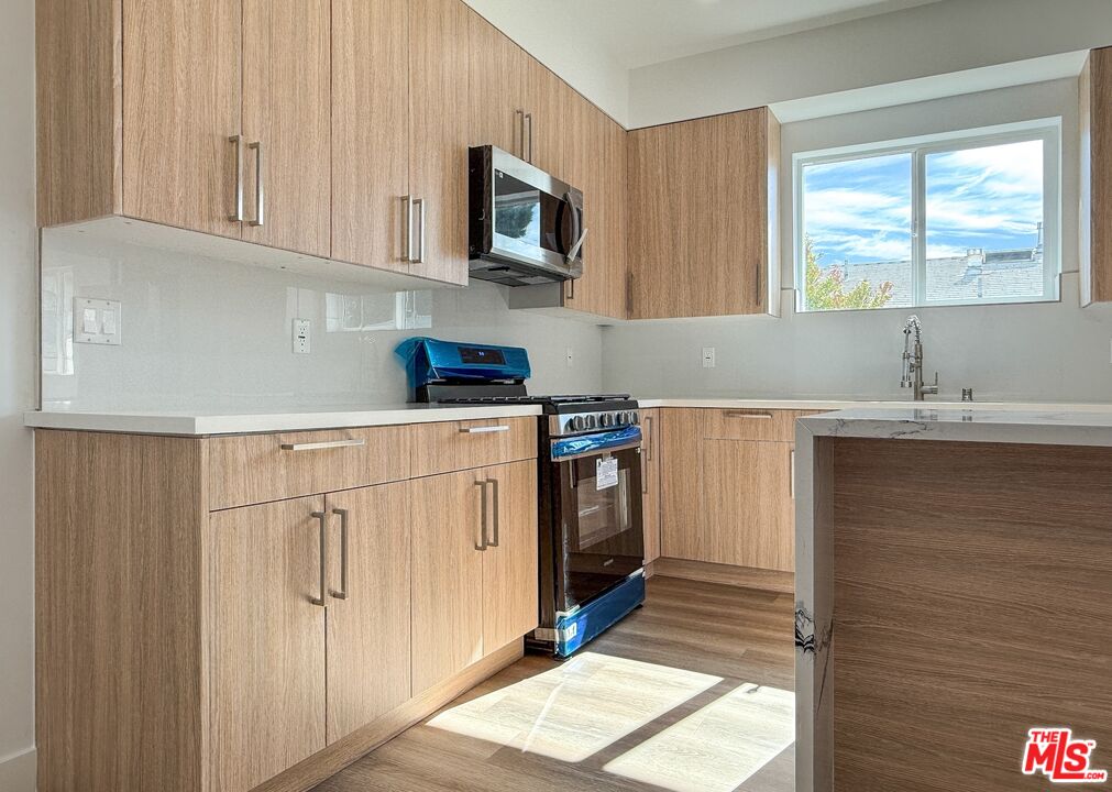 a kitchen with a sink cabinets and window