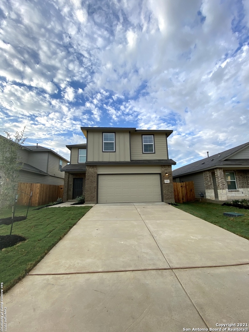 a front view of house with yard and trees