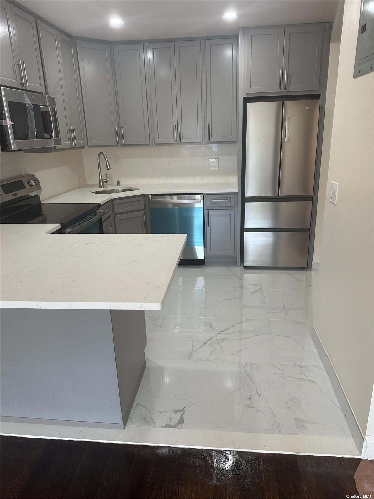 a kitchen with stainless steel appliances a refrigerator sink and cabinets