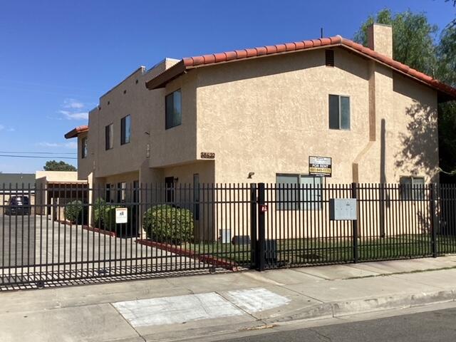 a front view of a house with a iron gate