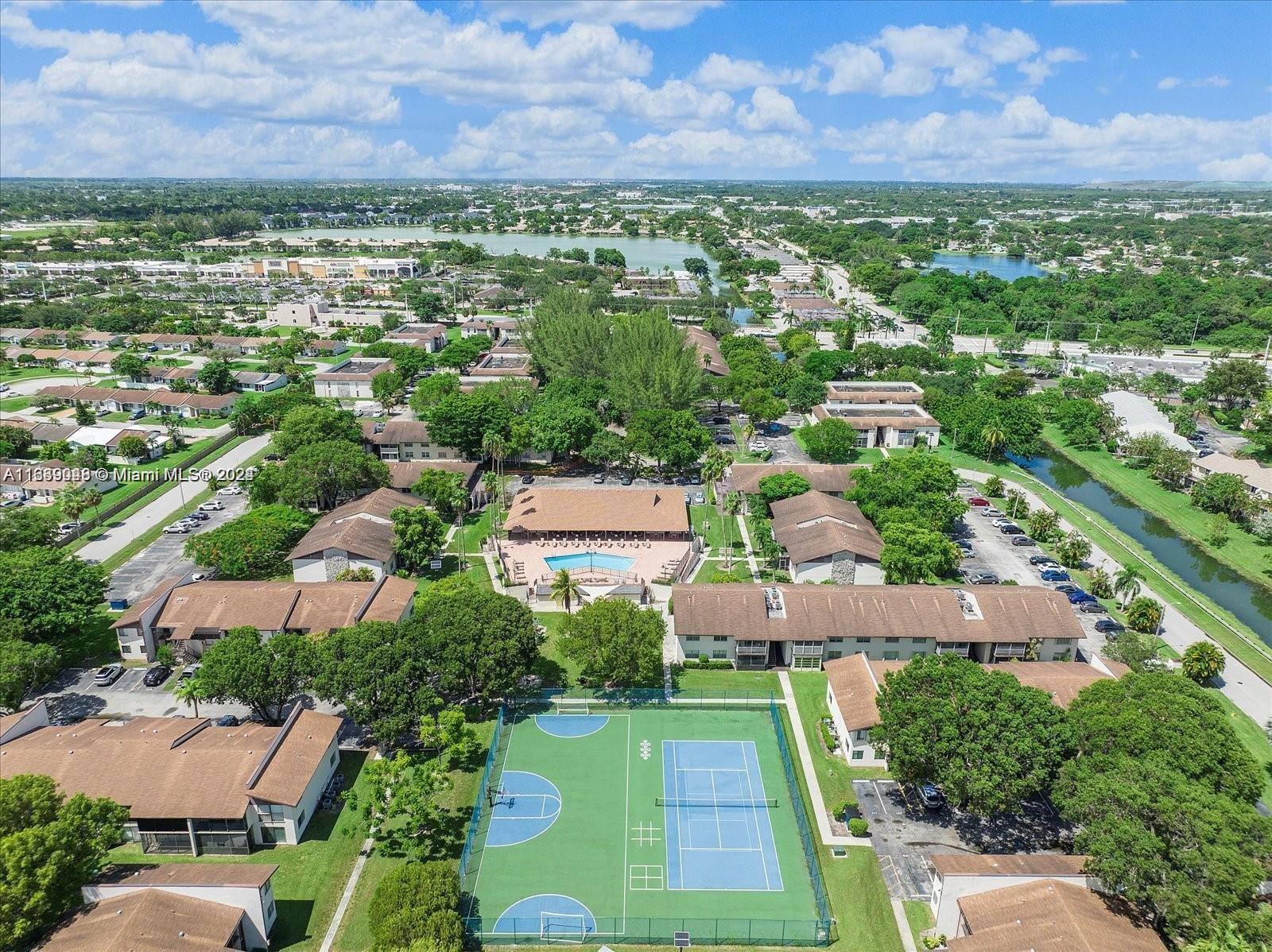 an aerial view of residential houses with outdoor space and garden