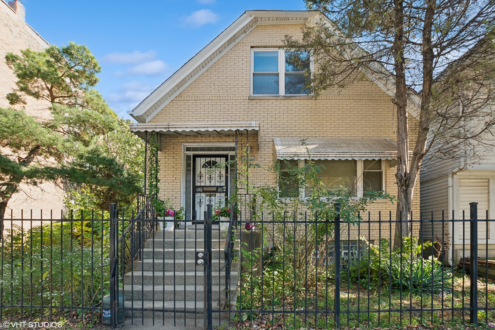 a front view of a house with a garden