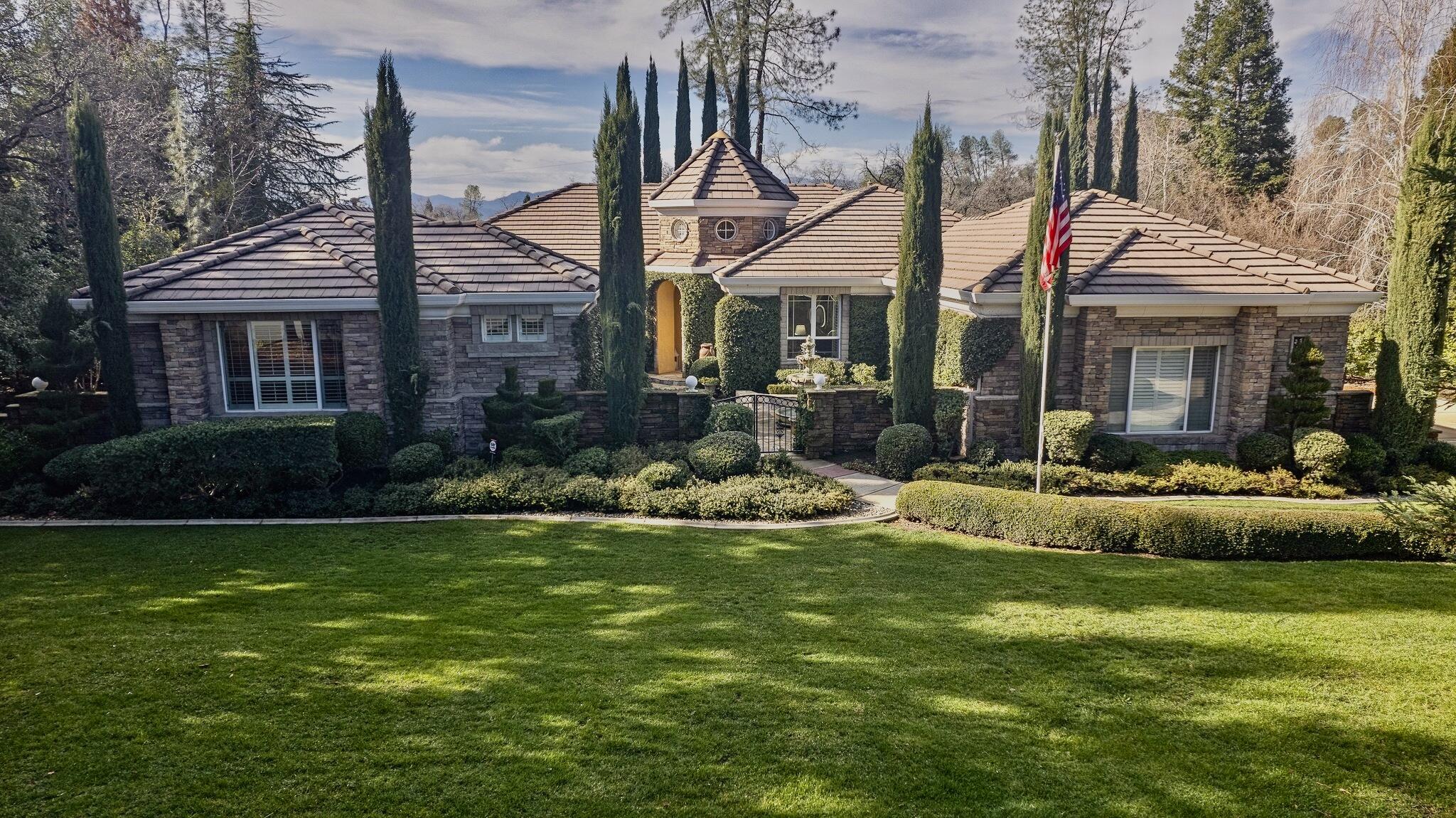 a view of a house with a yard patio and swimming pool