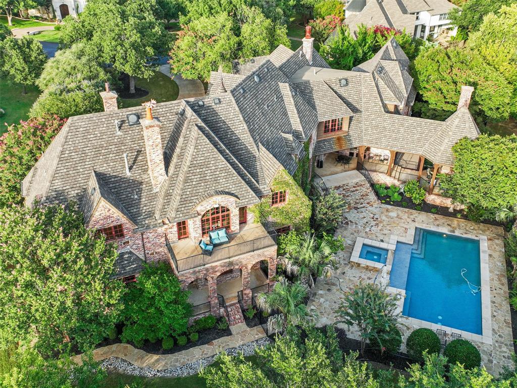 an aerial view of a house with a yard and trees