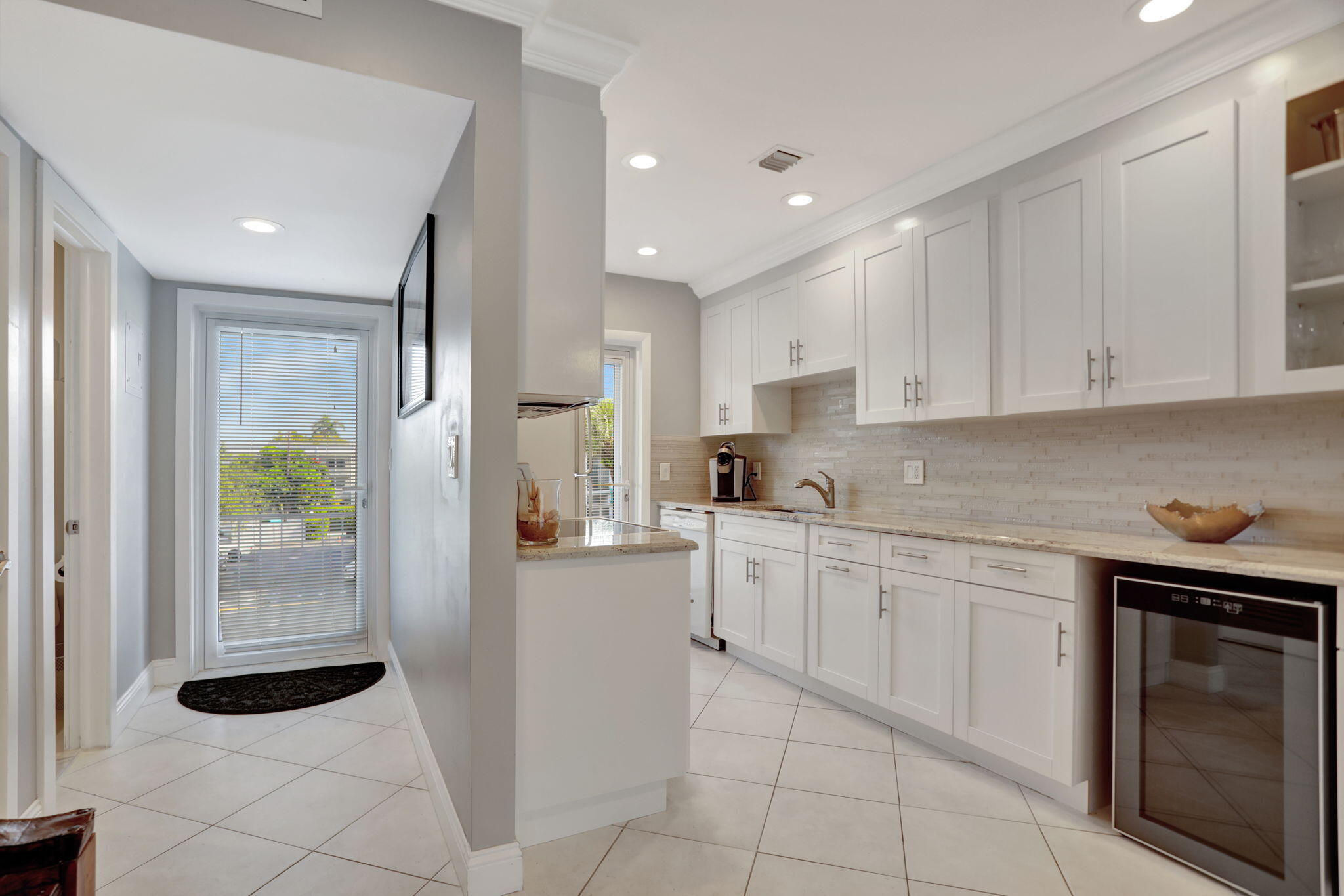 a kitchen with a sink window and cabinets