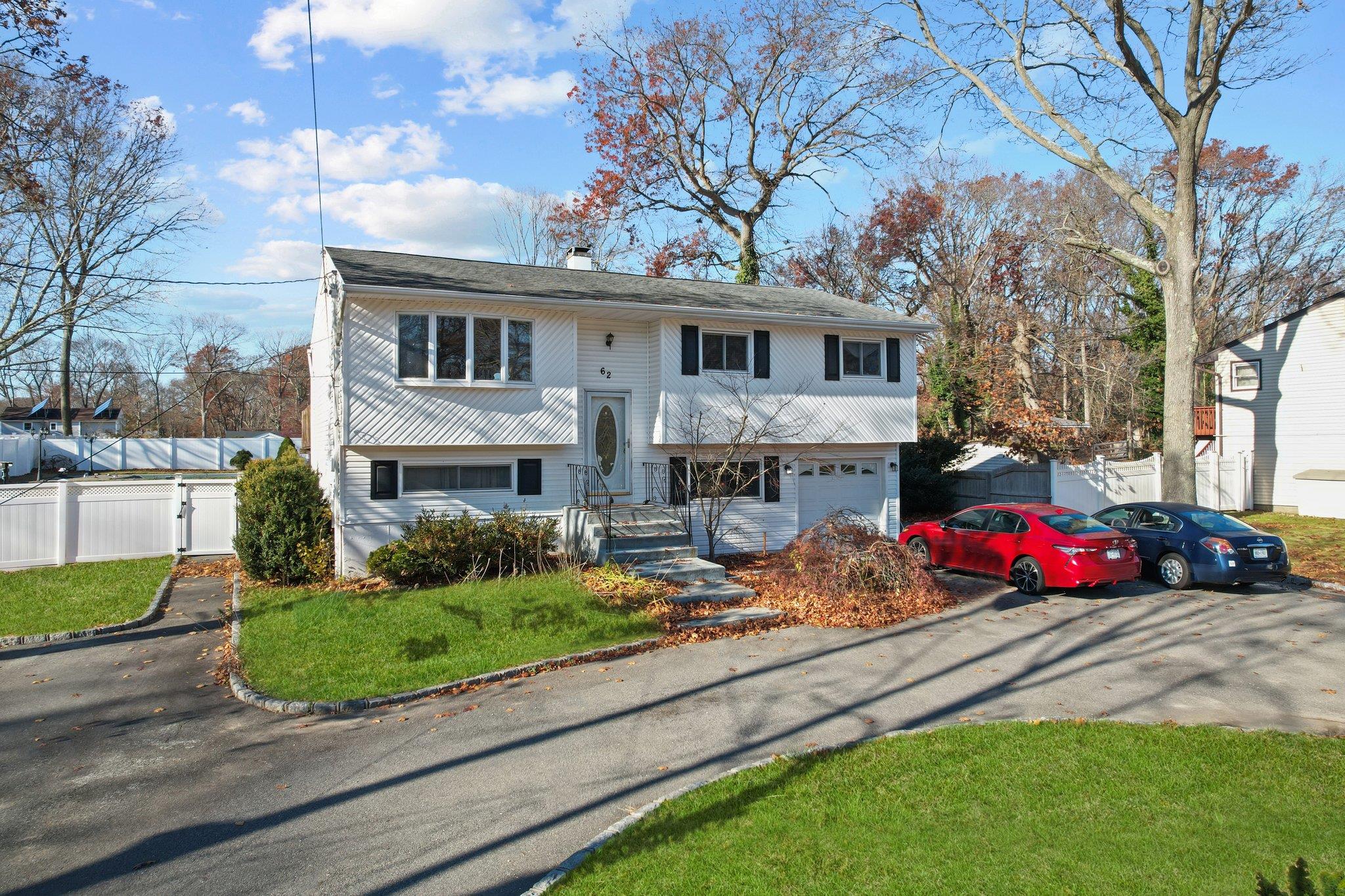 a front view of house with yard and green space