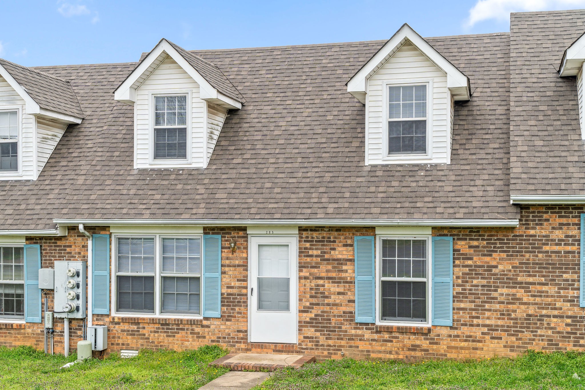 a front view of a house with a yard