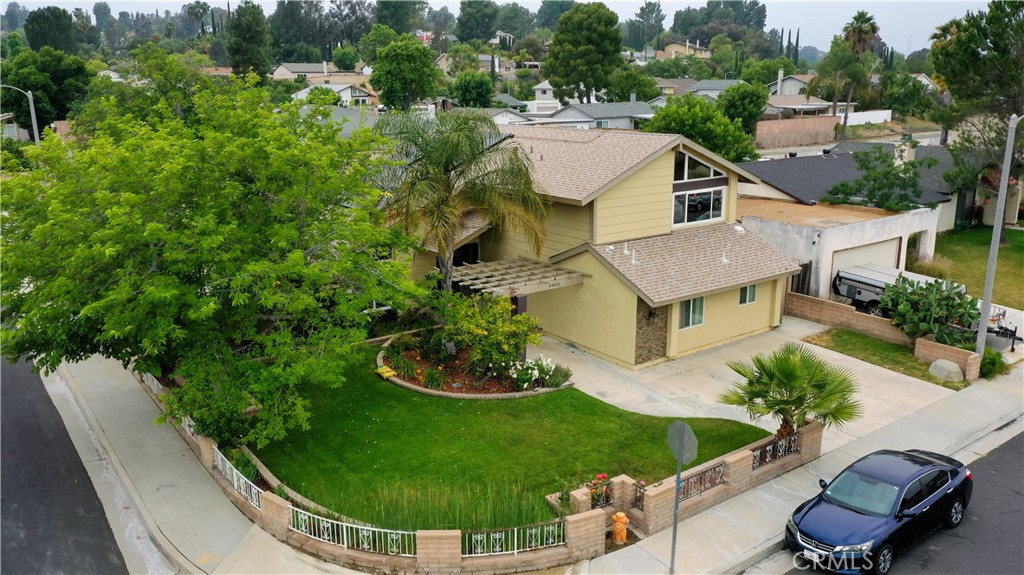 an aerial view of a house with garden space and street view