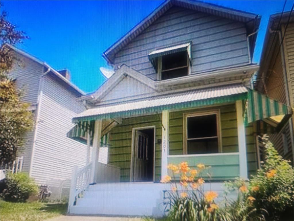 a view of yellow house with a large window