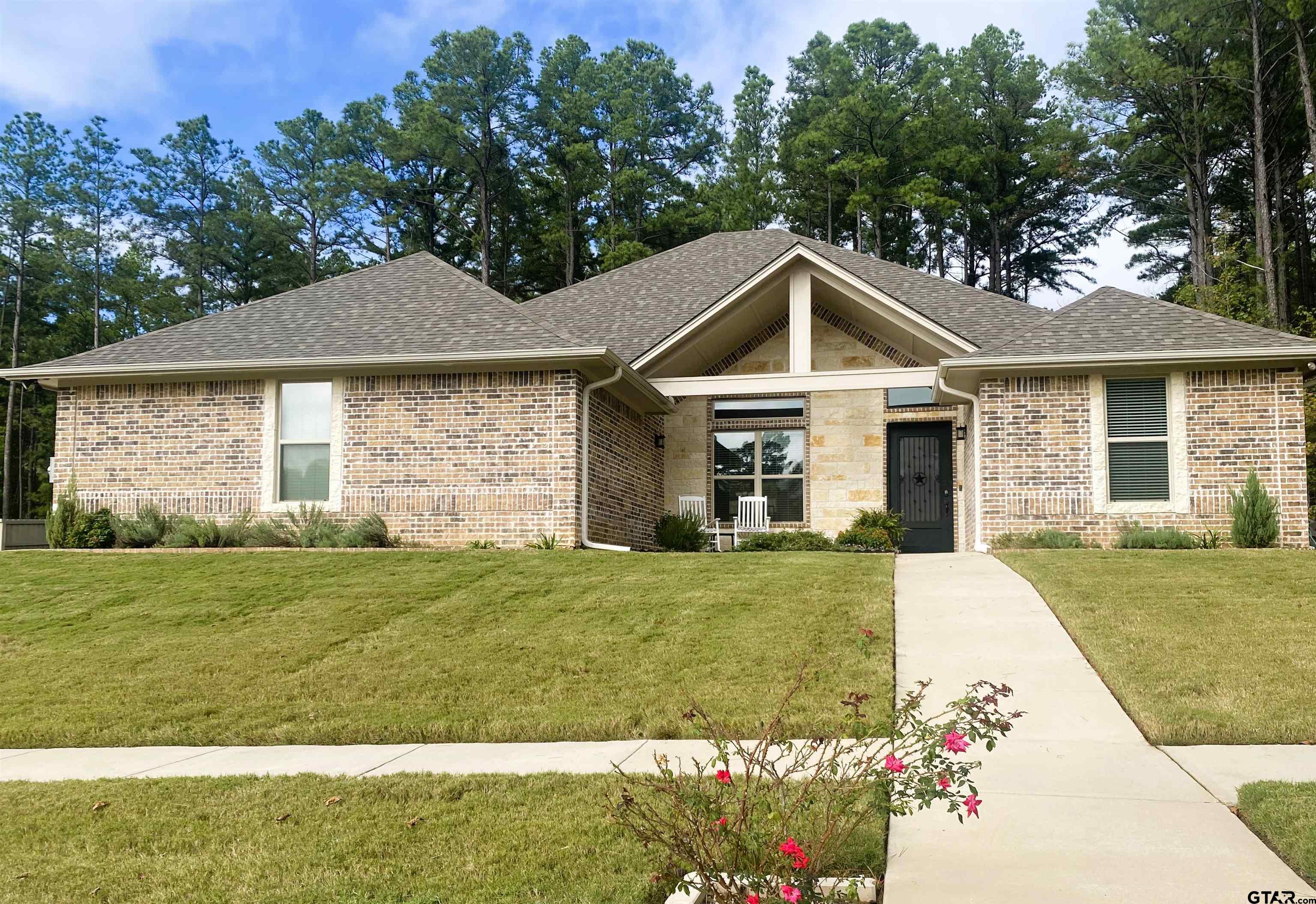 a front view of a house with a yard