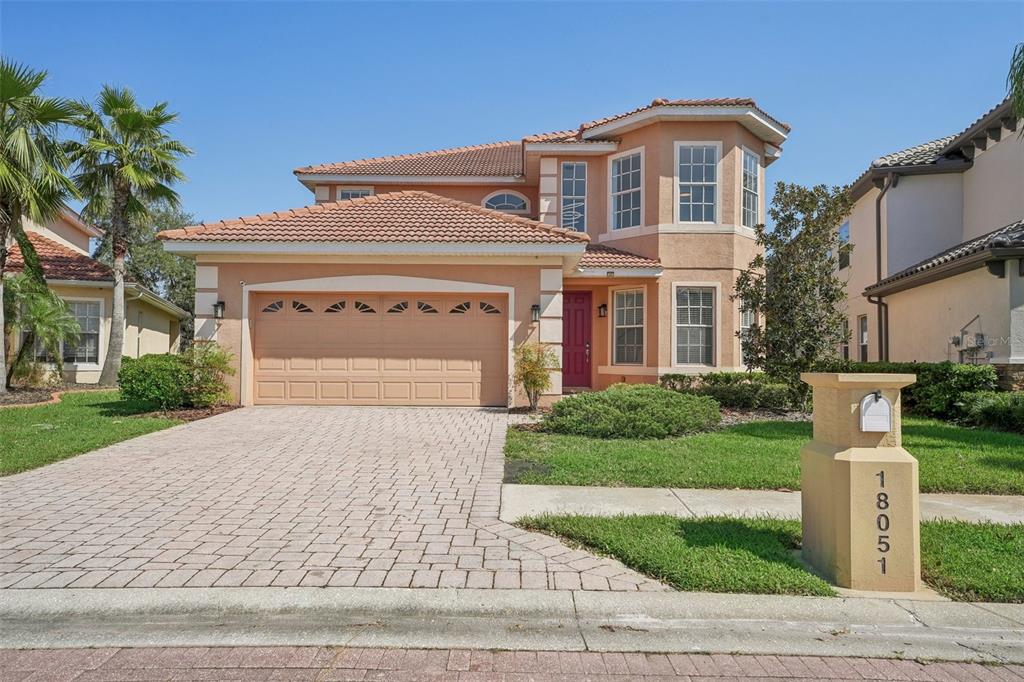 a front view of a house with a yard and garage