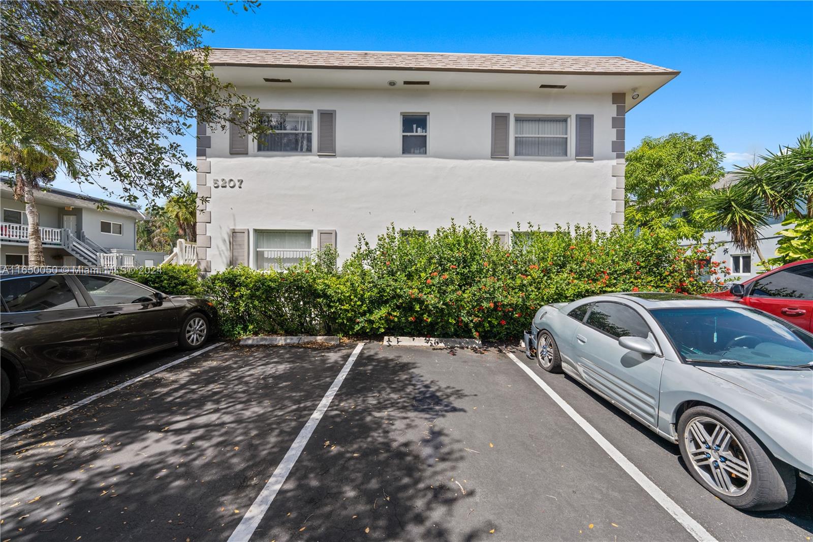 a view of a car parked front of a house