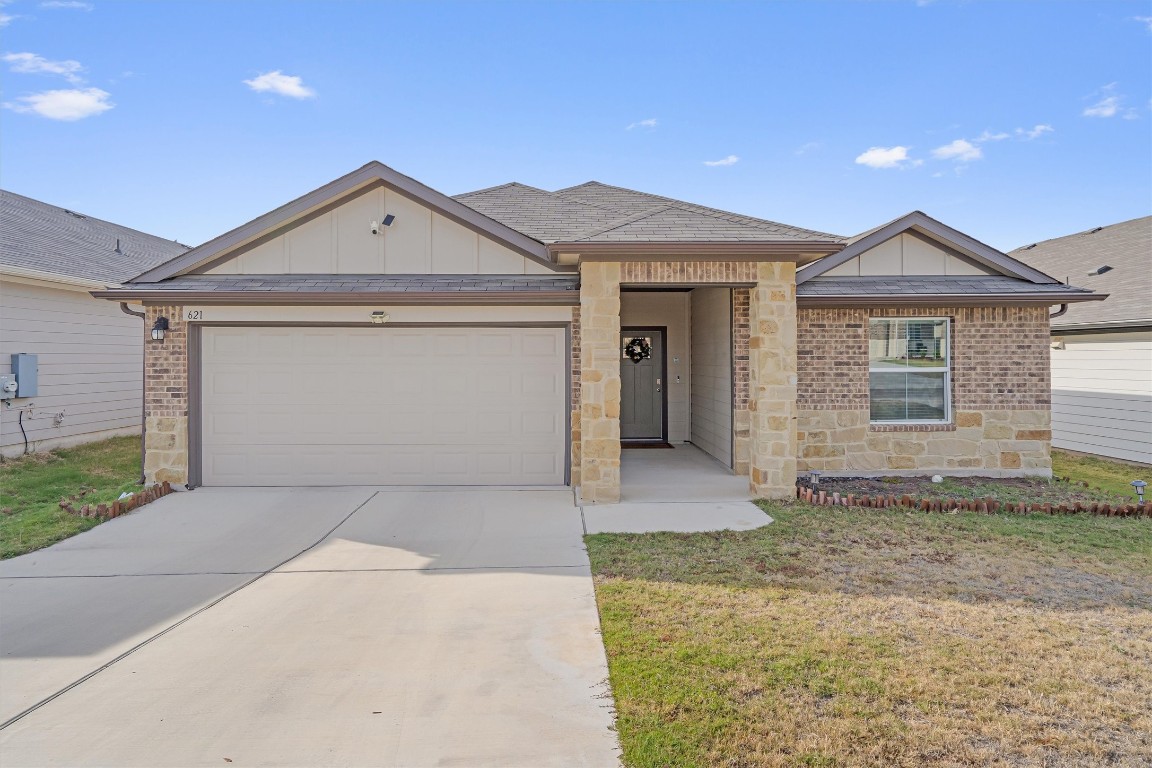 a front view of a house with a yard and garage