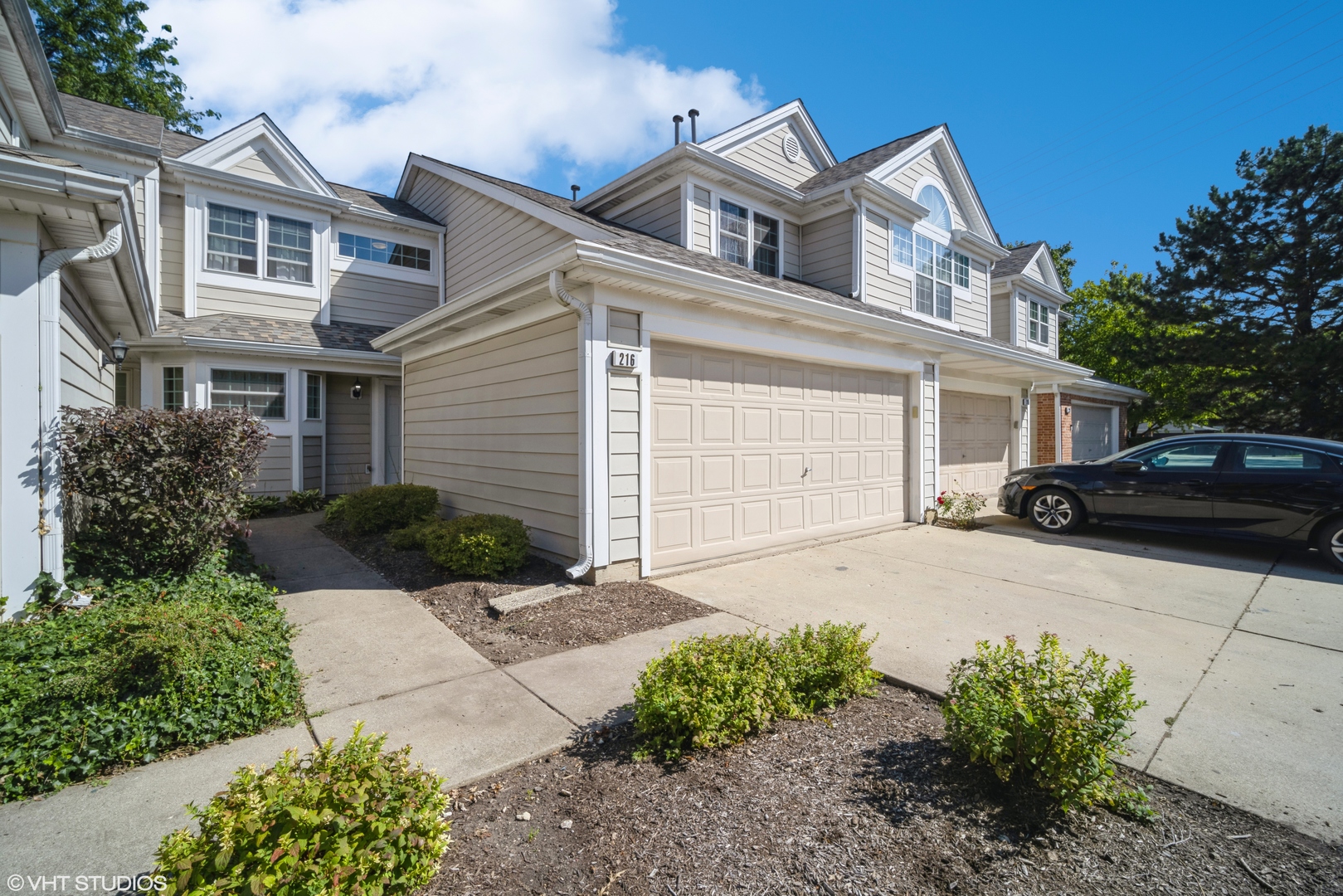 a front view of a house with a yard and garage