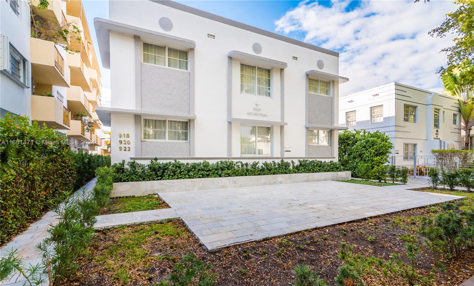 a view of a white apartments with large windows