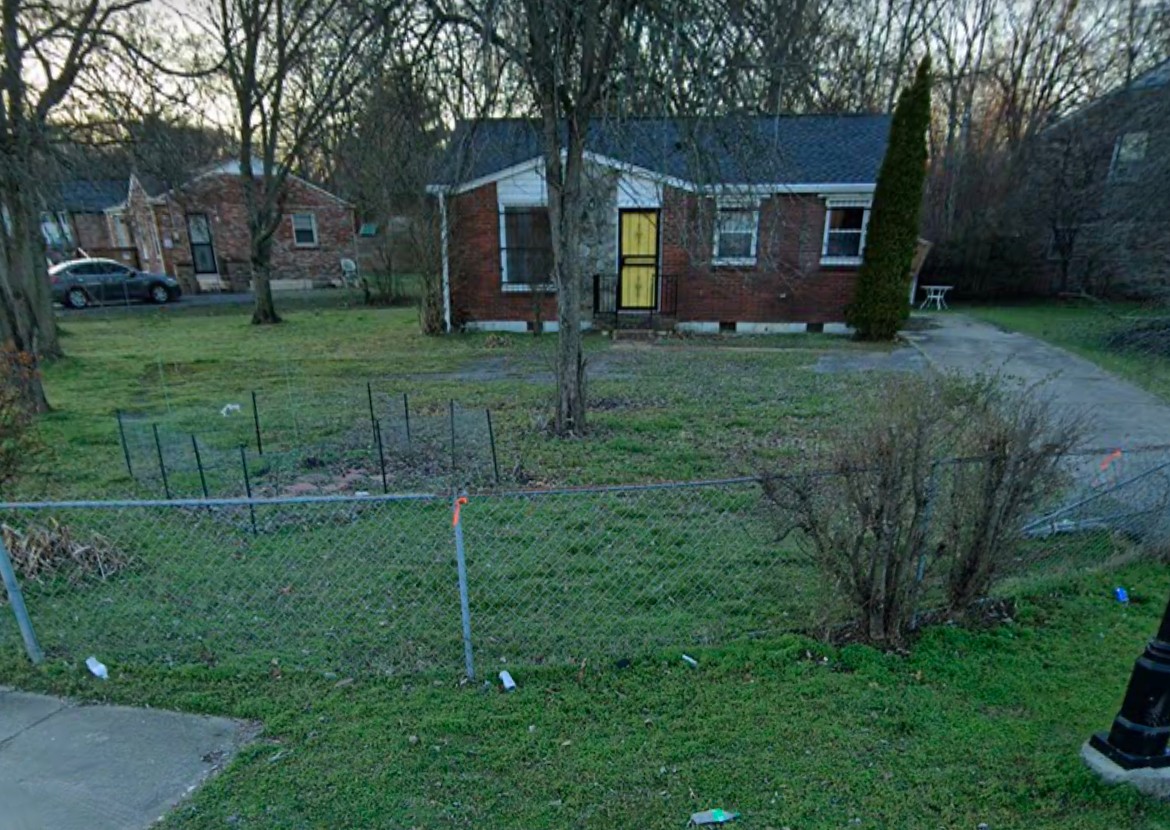 a view of a house with a big yard and large trees