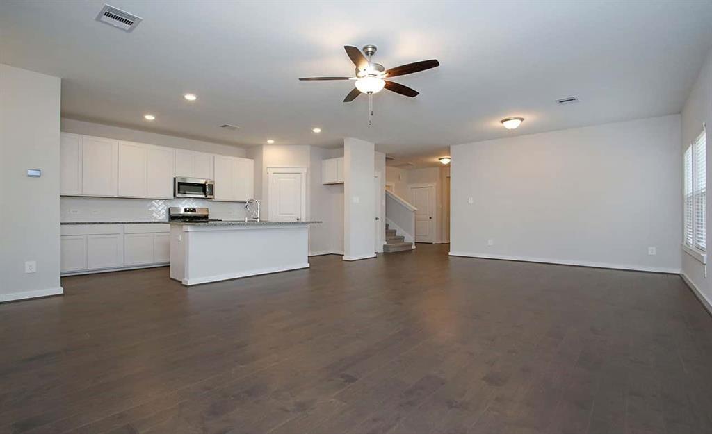 a view of a kitchen with a sink and cabinets