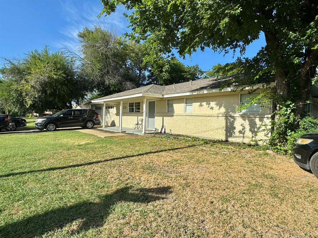 a view of an house with backyard space and garden