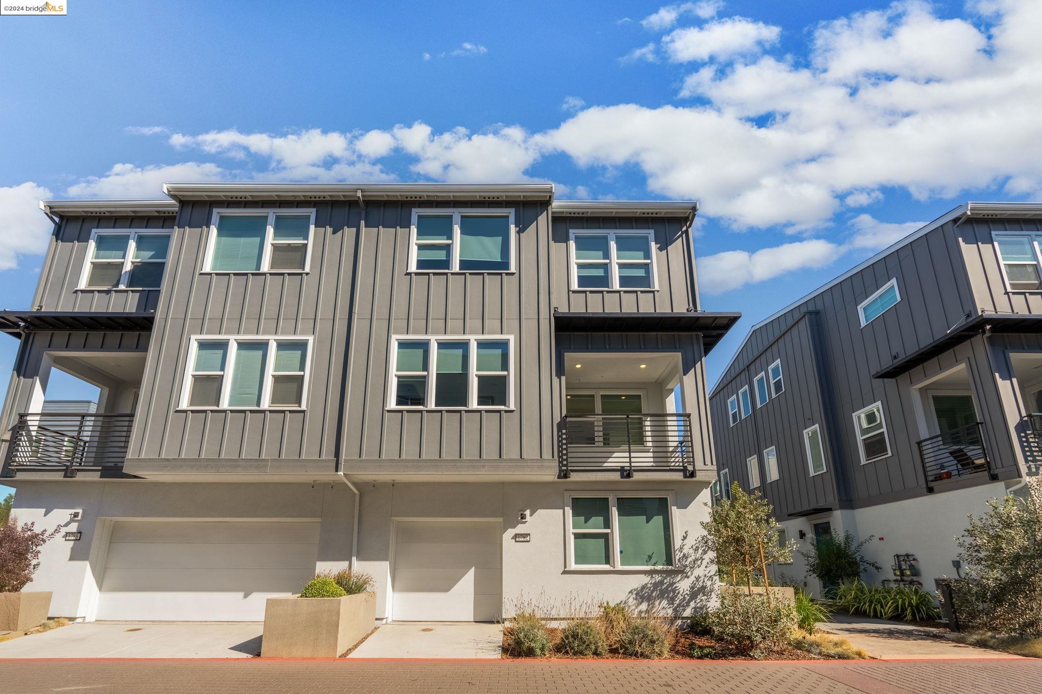 a front view of a residential apartment building with a yard