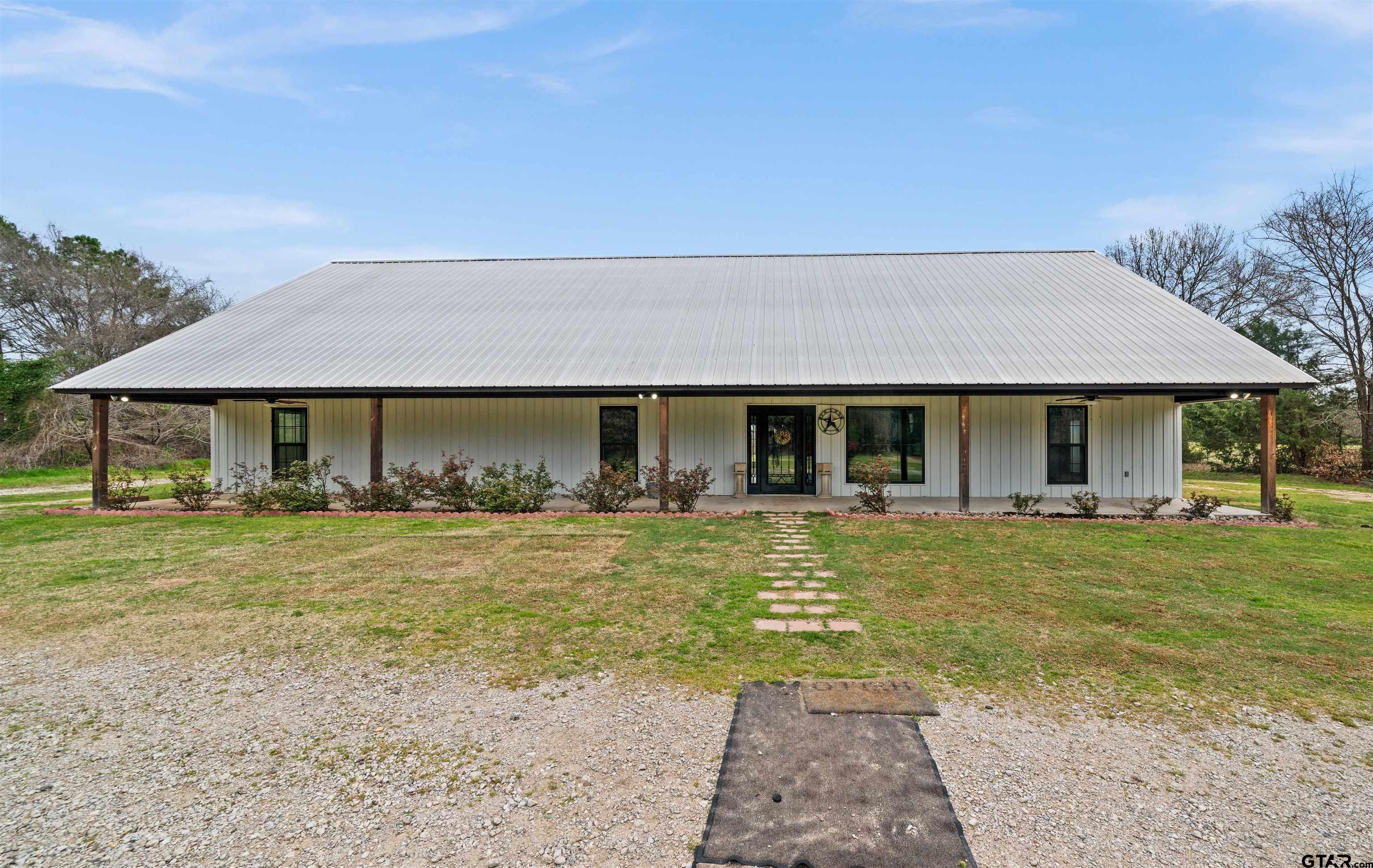 a front view of a house with a garden and porch