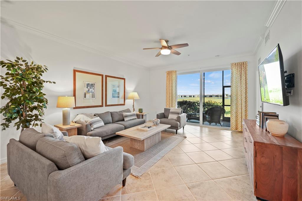 a living room with furniture a flat screen tv and a large window