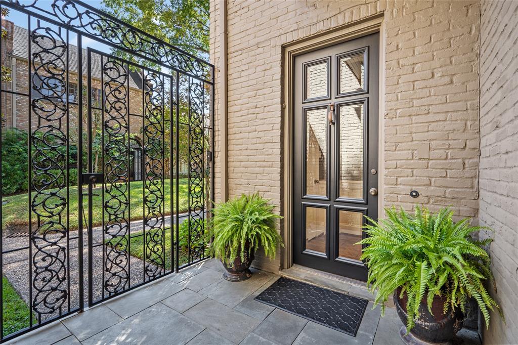 From a lovely courtyard, a beautiful wrought iron gate allows private entrance to the leaded glass front door. The porch is laid with blue stone.