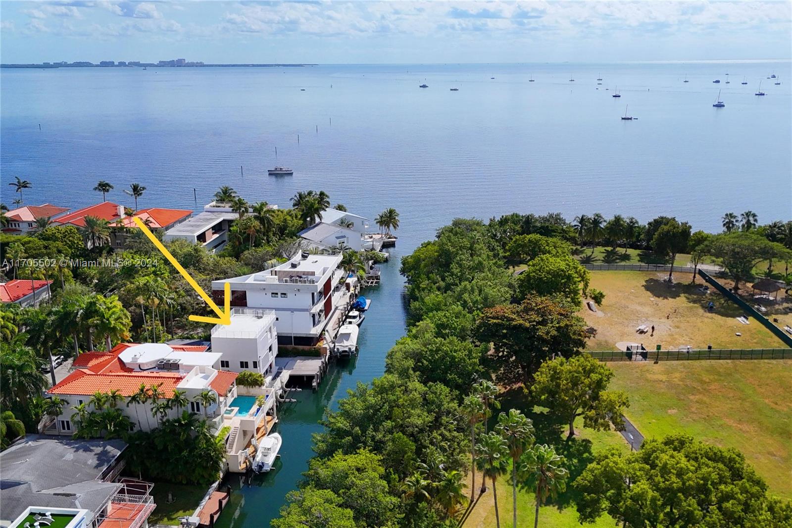 an aerial view of a house with a yard and lake view