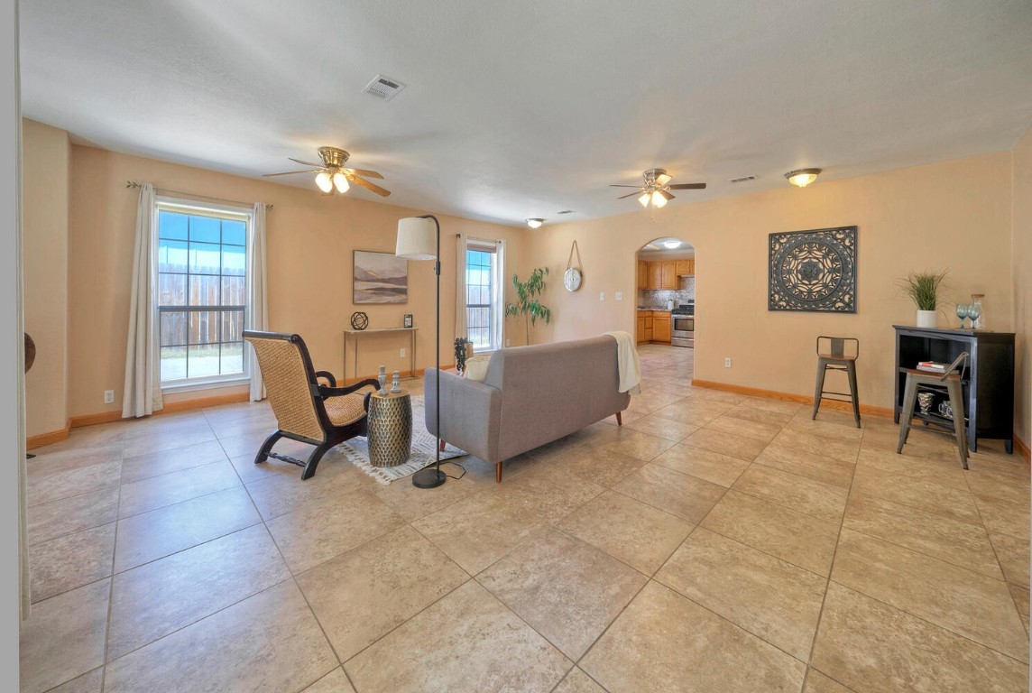 a living room with furniture and a dining table