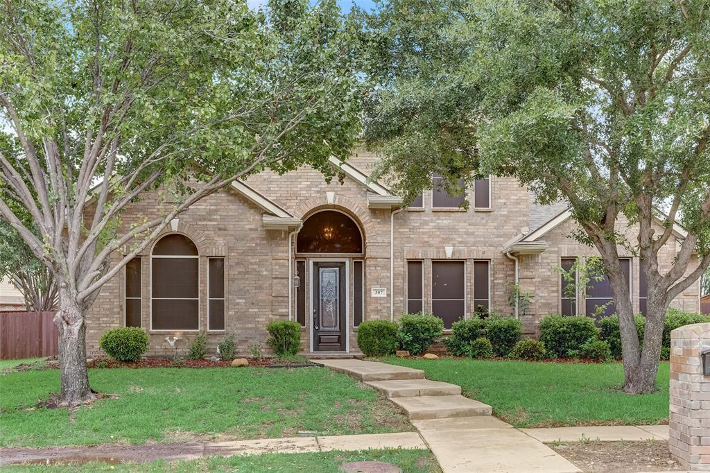 front view of a house with a yard