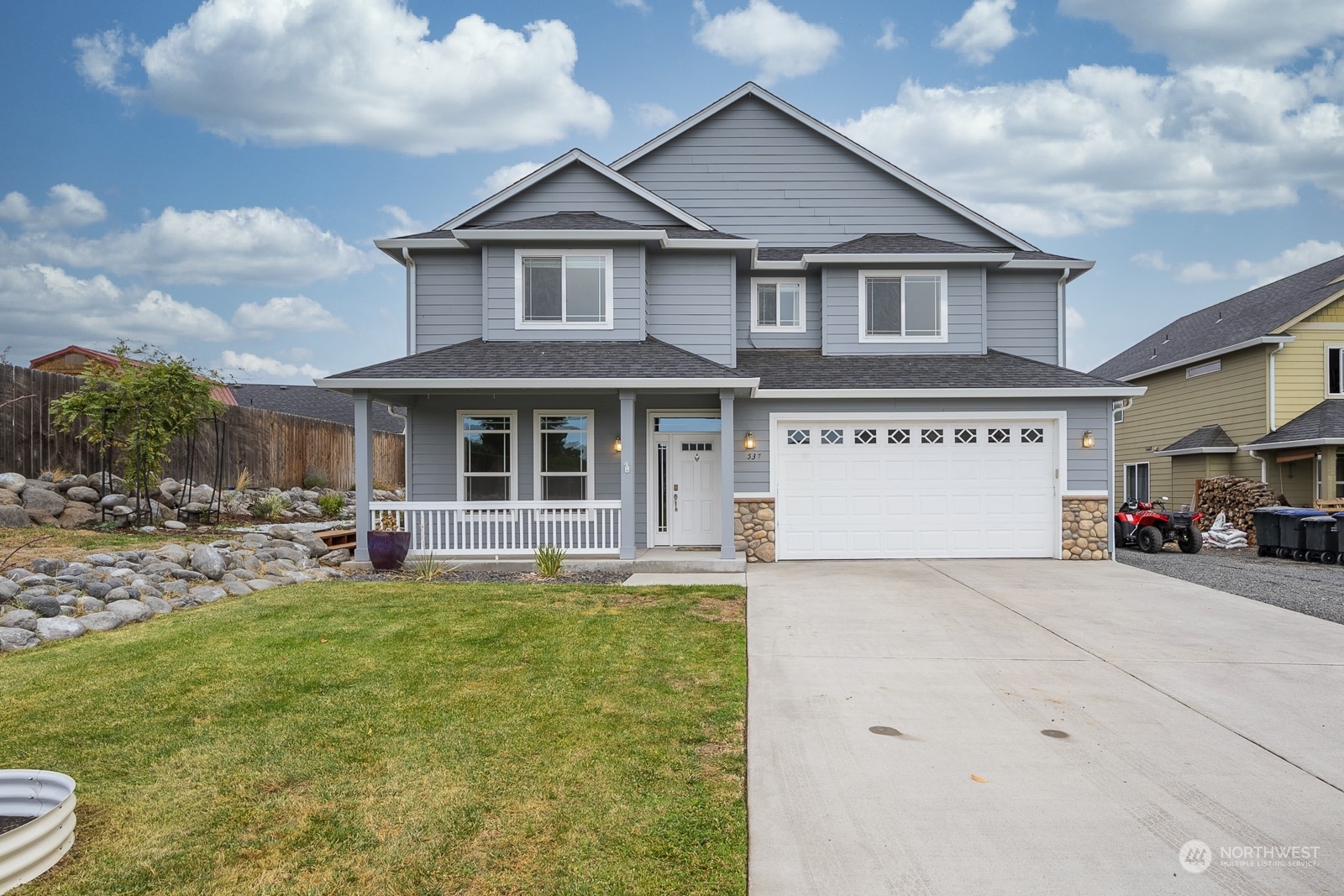 a view of a house with a patio and a yard