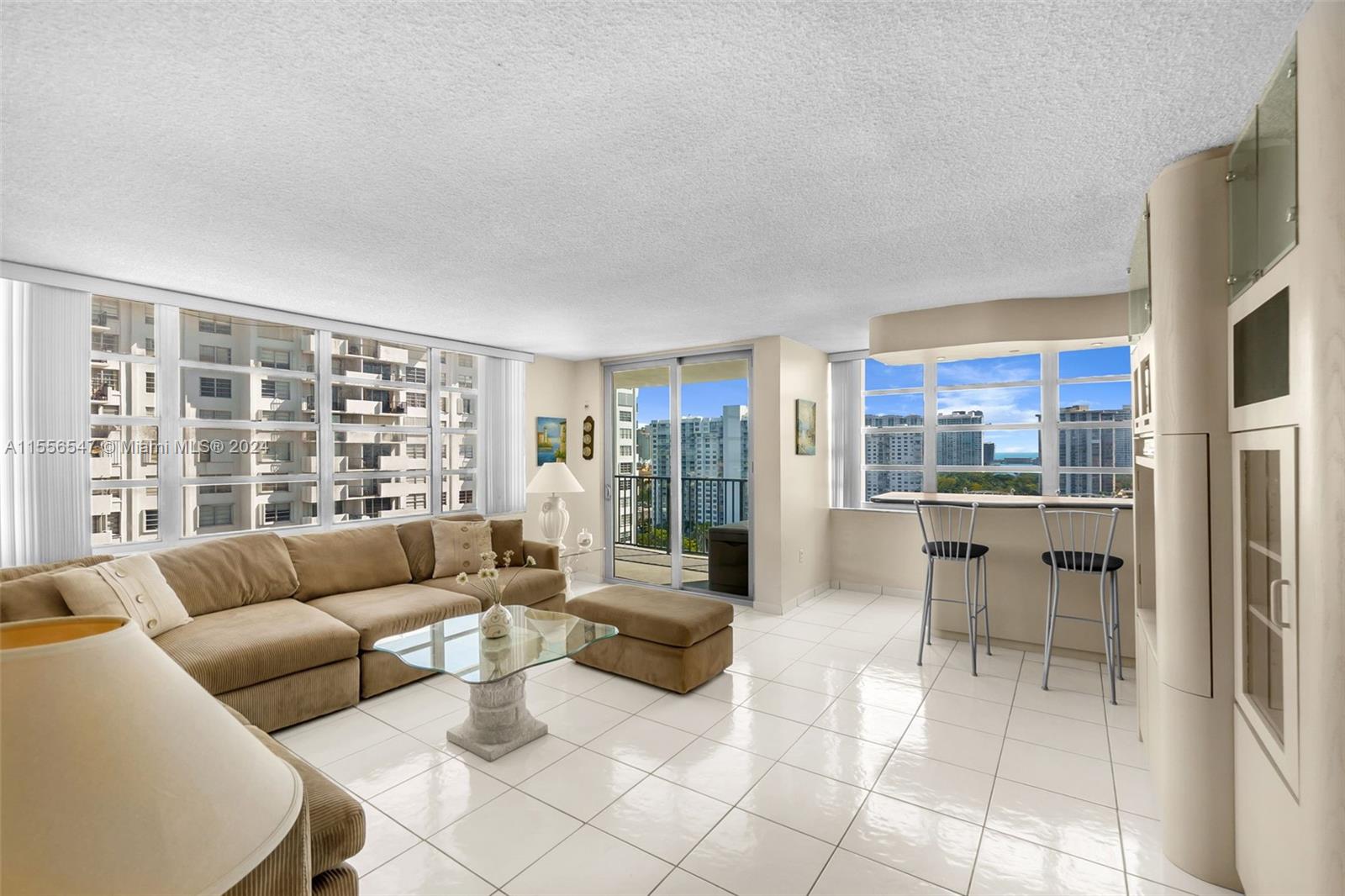 a living room with furniture and a floor to ceiling window