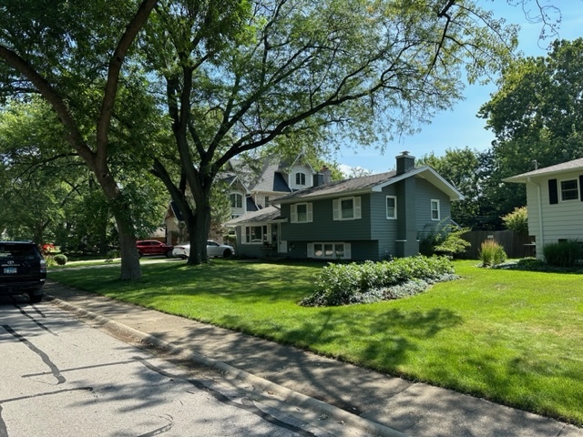 a front view of house with yard and green space