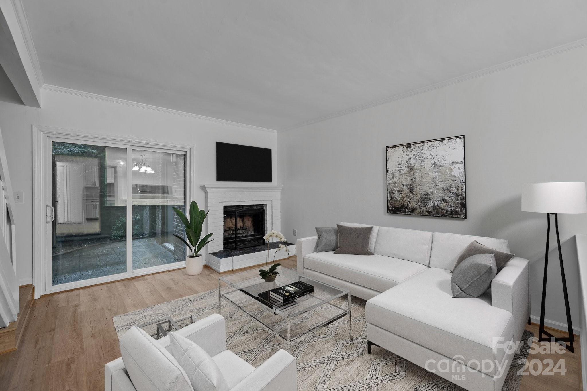 a living room with furniture a fireplace and a flat screen tv