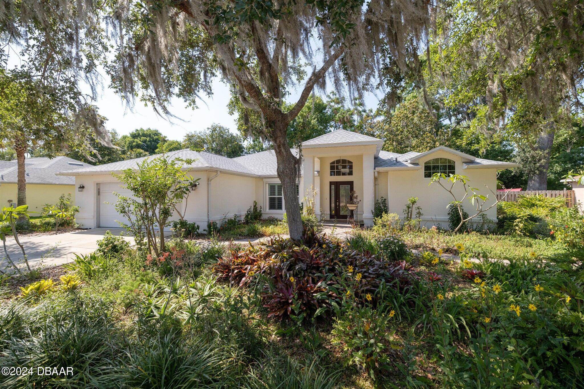 a front view of a house with garden