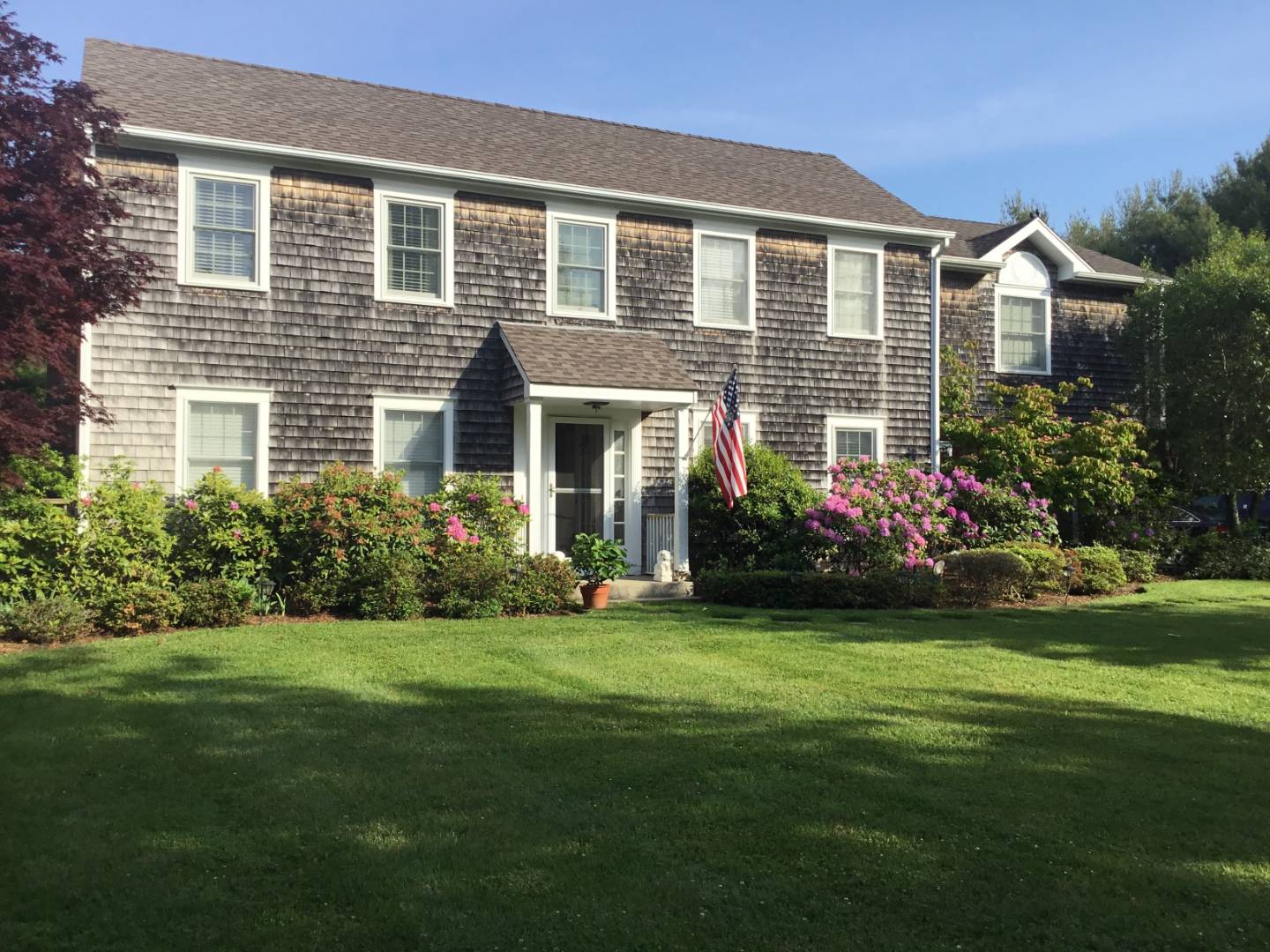 a front view of house with yard and green space