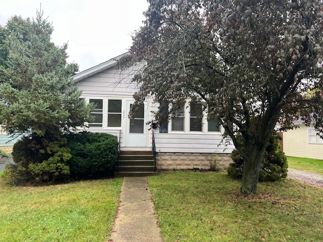 a view of house with backyard and garden