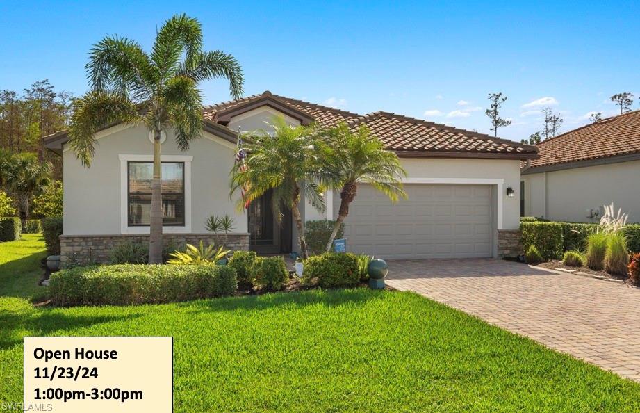 Mediterranean / spanish-style house with a front yard and a garage