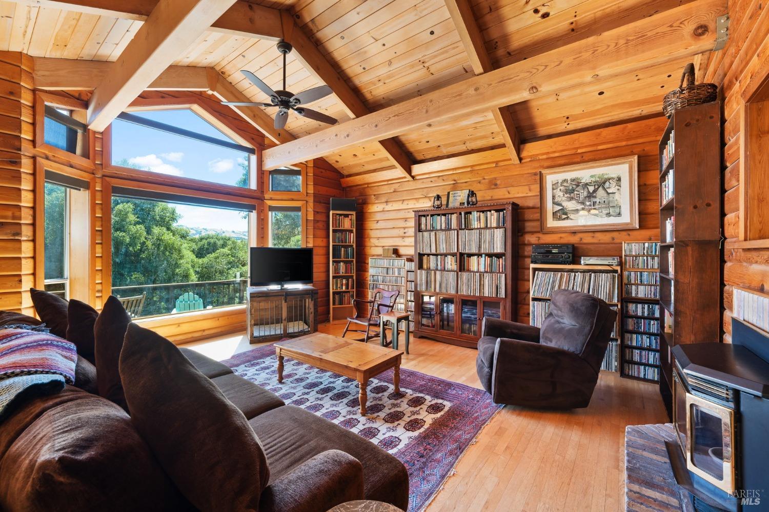 a living room with fireplace furniture and a floor to ceiling window