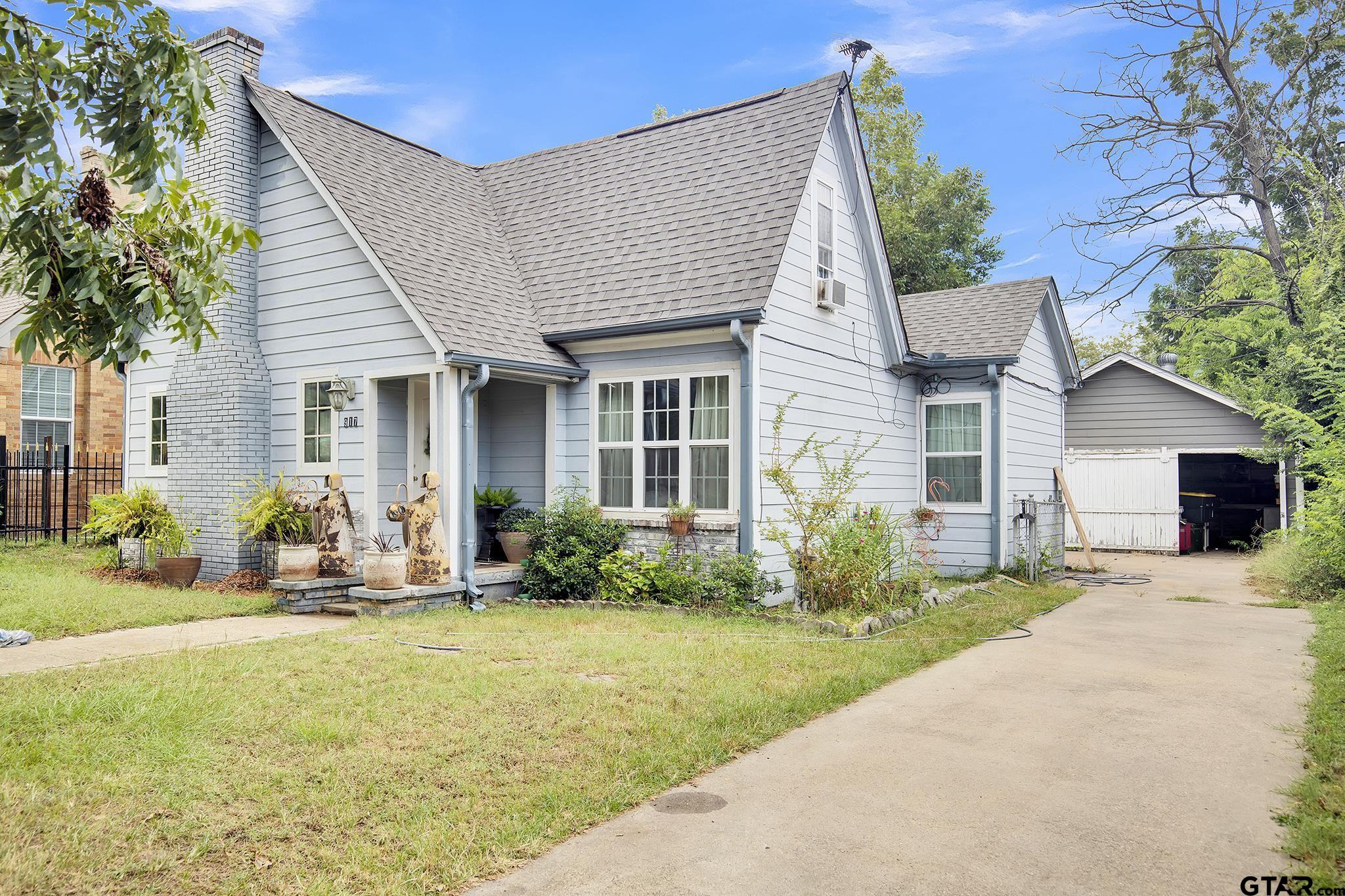 a front view of house with yard outdoor seating and barbeque oven