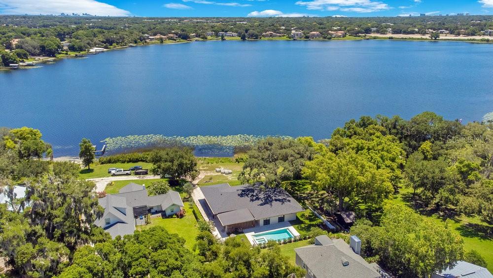 an aerial view of a houses with a lake view