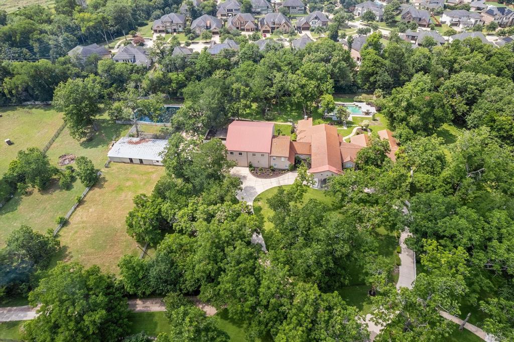 an aerial view of a house with a yard and lake view